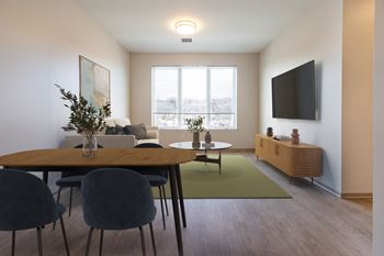 A modern dining room with a wooden table and chairs